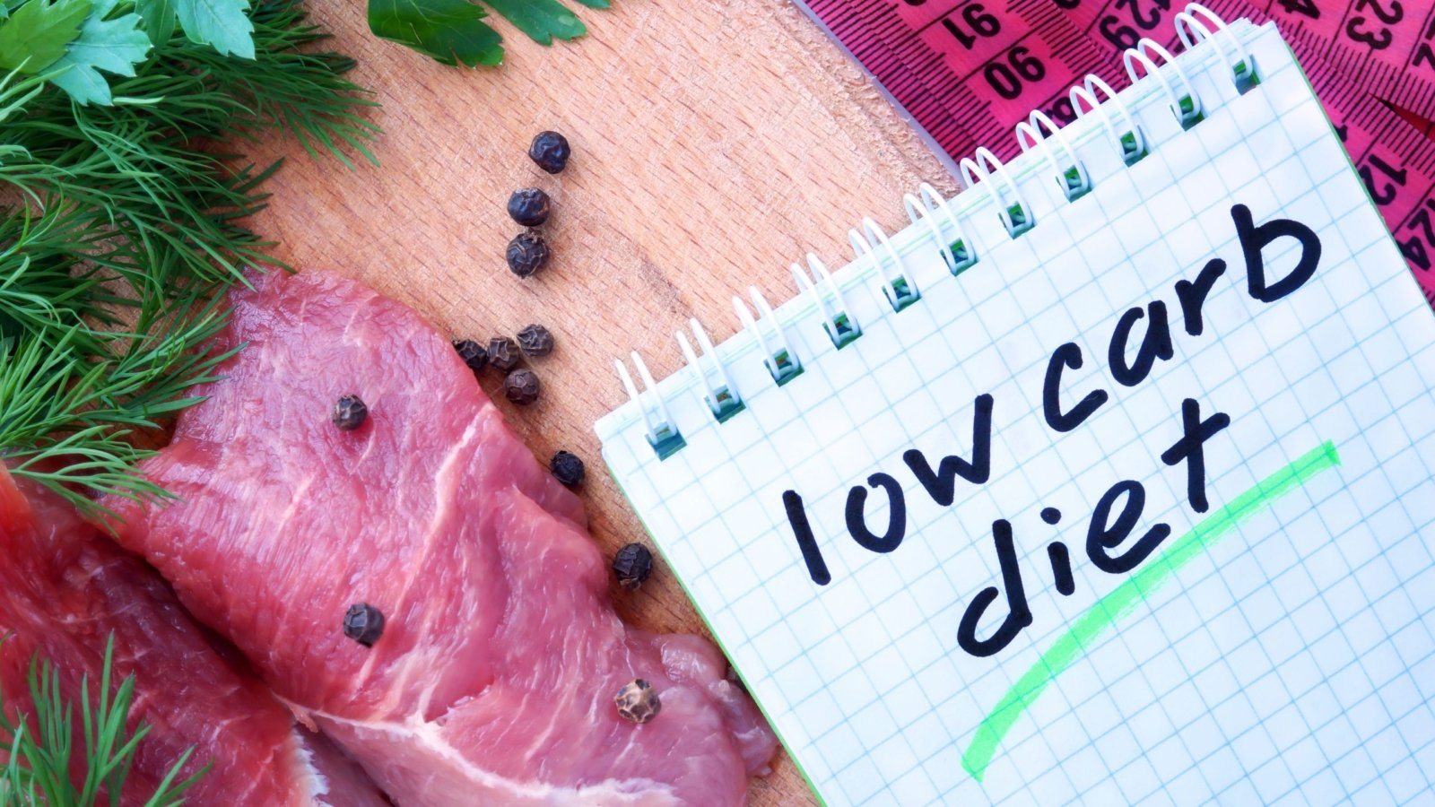 A scribble pad on which is written the phrase "Low-Carb Diet".