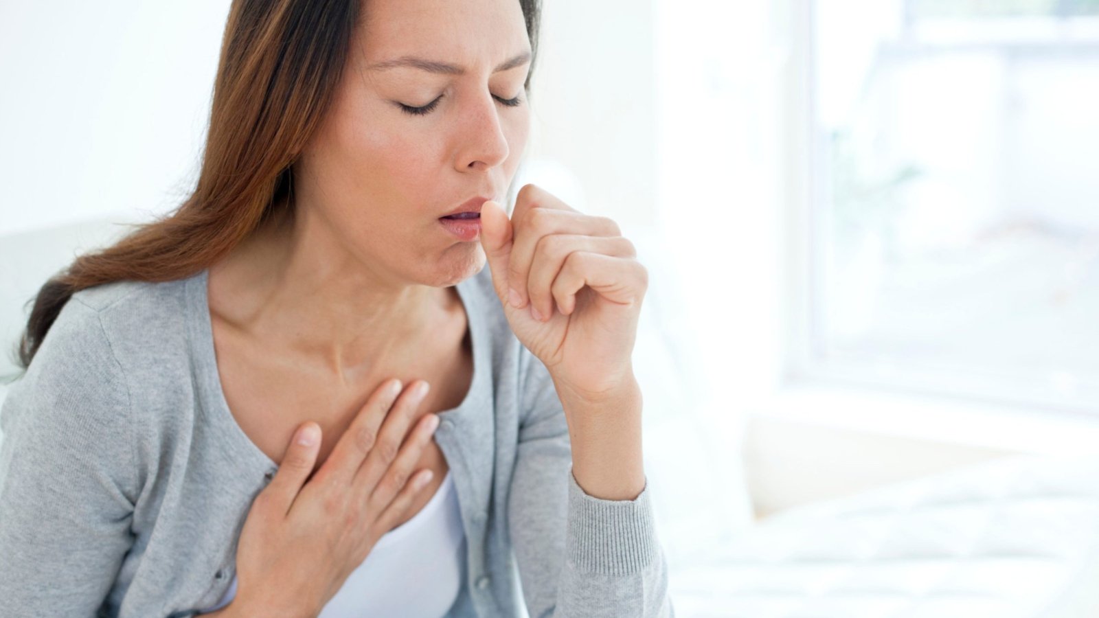 A young woman suffering from persistent cough.