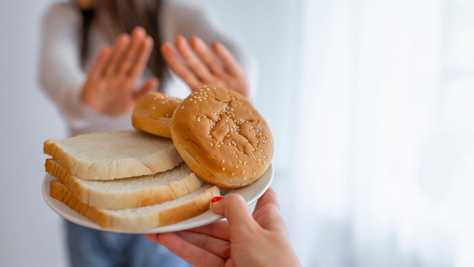 Hands of a woman gesturing a big No to foods containing Gluten for fear of Gluten Intolerance.