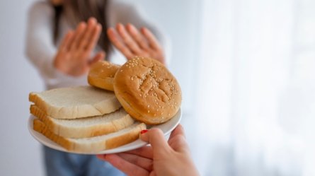 Hands of a woman gesturing a big No to foods containing Gluten for fear of Gluten Intolerance.