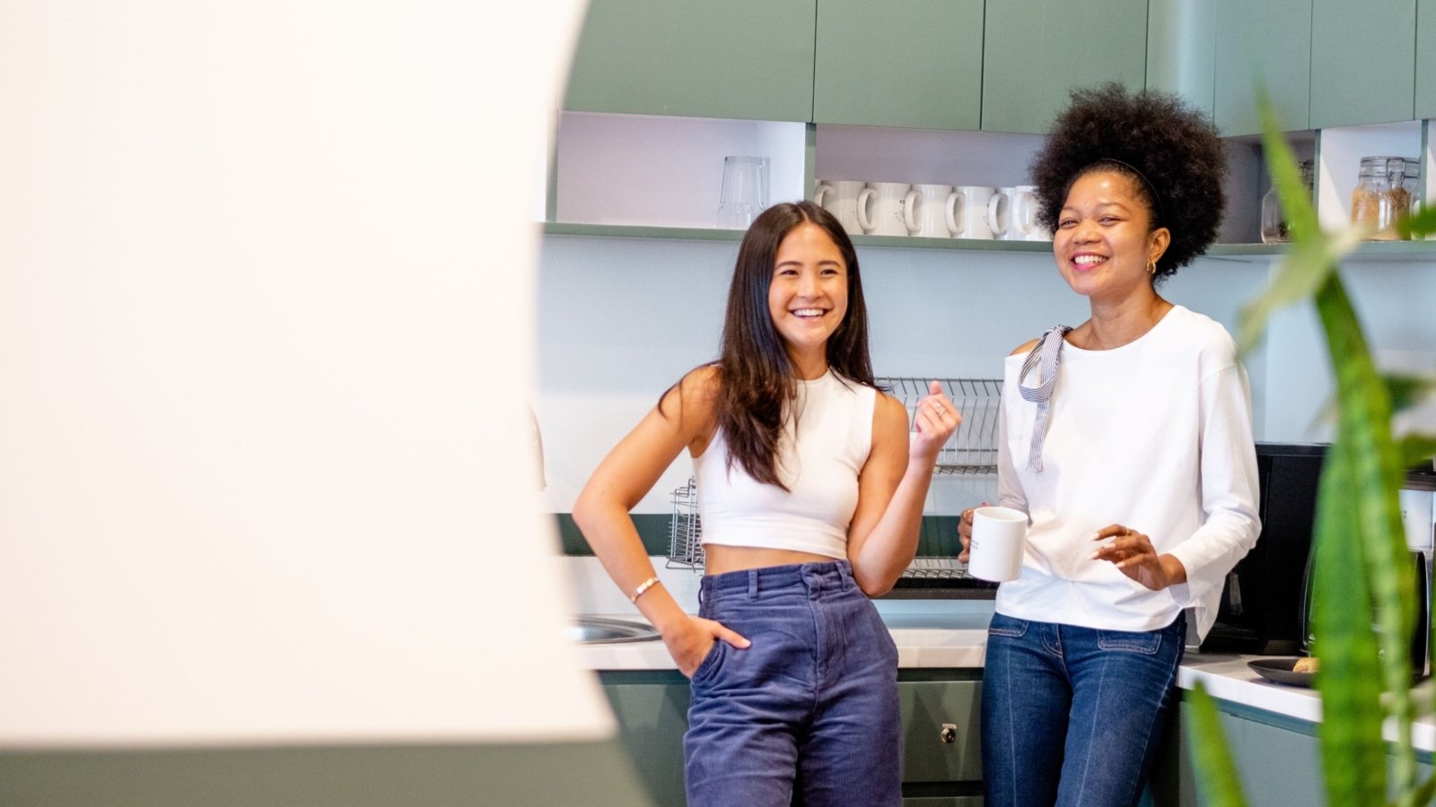 Two women enjoying some Stress Relieving Foods at their office pantry.